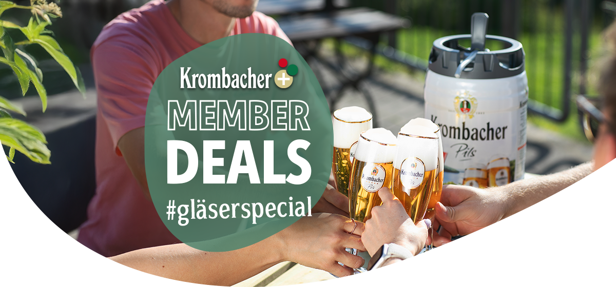 Vier Gläser mit Krombacher Pils, die von mehreren Personen zum Anstoßen gehalten werden, neben einem Krombacher Pils Frische-Fässchen auf einem Tisch im Freien.
