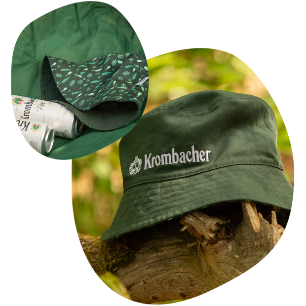 Grüner Krombacher Bucket Hat mit weißem Krombacher Logo auf Baumstamm, Innenfutter mit Mustern