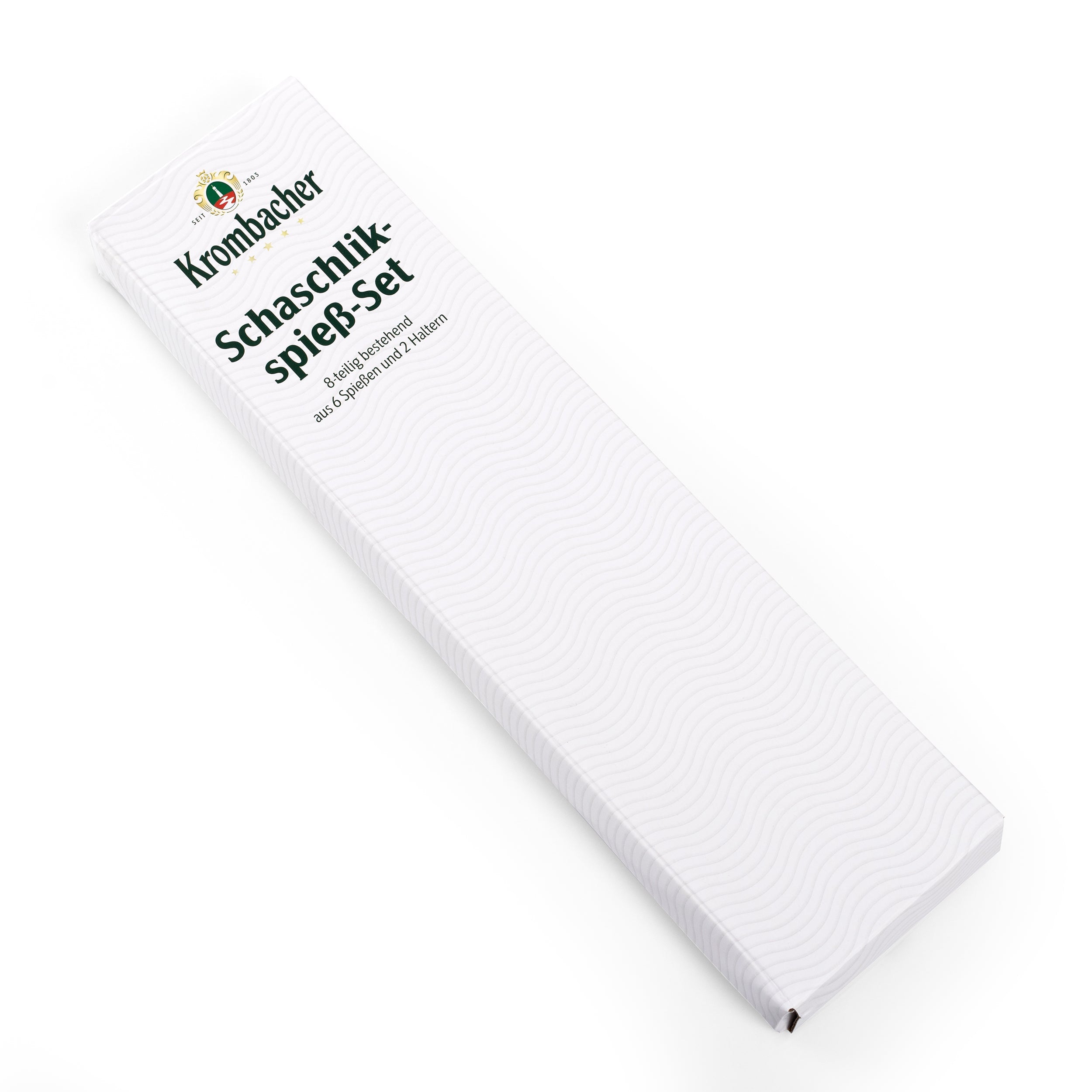 Verpackung des Krombacher Schaschlikspieß-Sets mit Aufschrift und Logo, länglich und weiß mit feinem Wellenmuster.