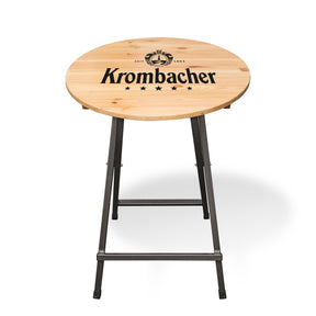 Runder Stehtisch mit hellem Holzplatte und dunkelgrauen Metallgestell, Platte mit schwarzem Krombacher-Logo und fünf Sternen bedruckt.