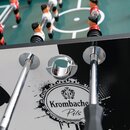 Krombacher Pils Kickertisch mit Spielfiguren in Rot und Weiß auf grünem Spielfeld, Metallstangen und Ballauswurföffnung.