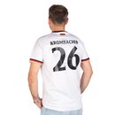 Mann von hinten mit weißem Trikot mit schwarzer Nummer 26 und Schriftzug 'KROMBACHER'.